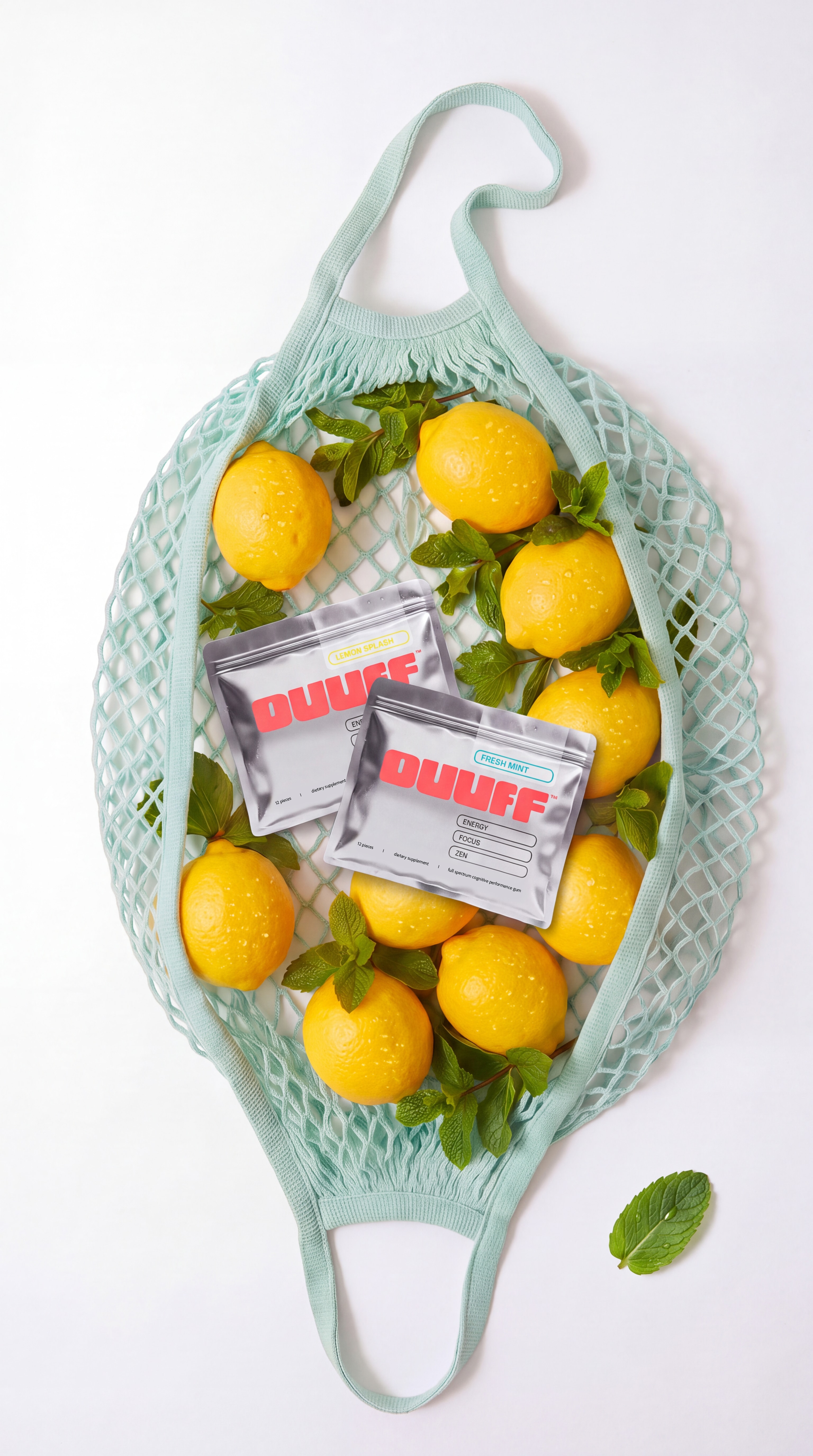 Two OUUFF pouches in a mint green net bag full of lemons